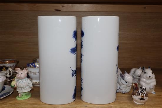 A pair of Chinese blue and white oval section sleeve vases height 25cm (one a.f.)